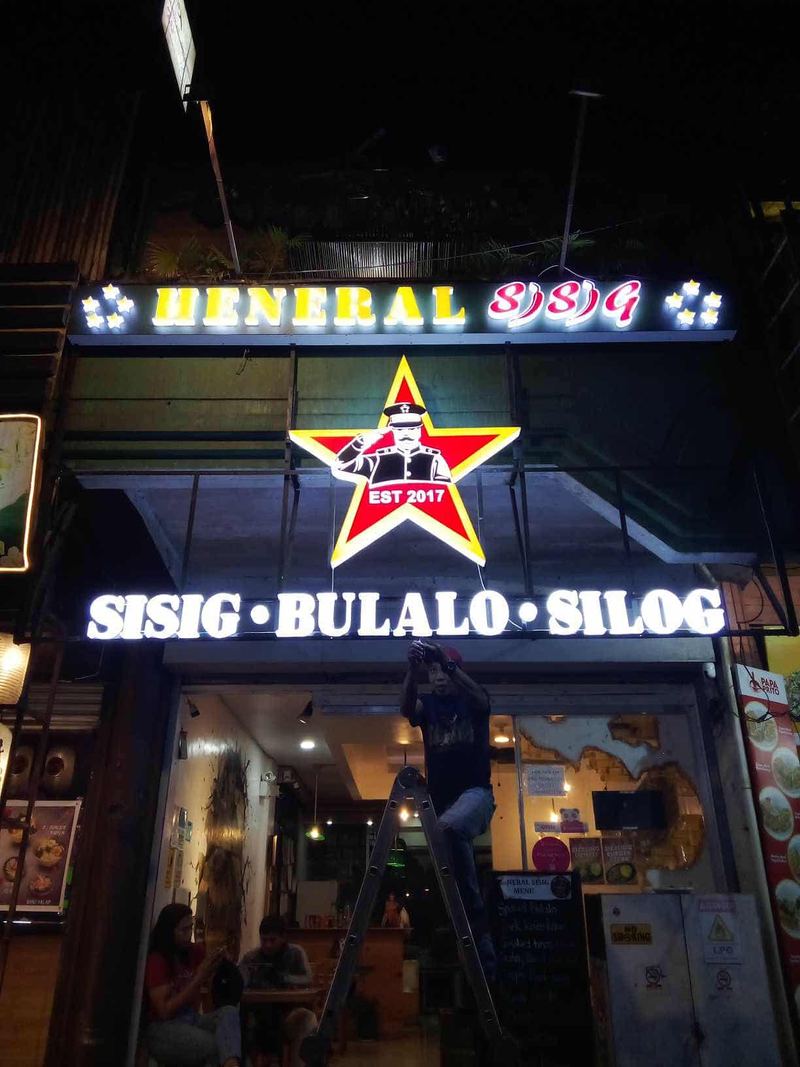 Heneral Sisig restaurant with lit star sign