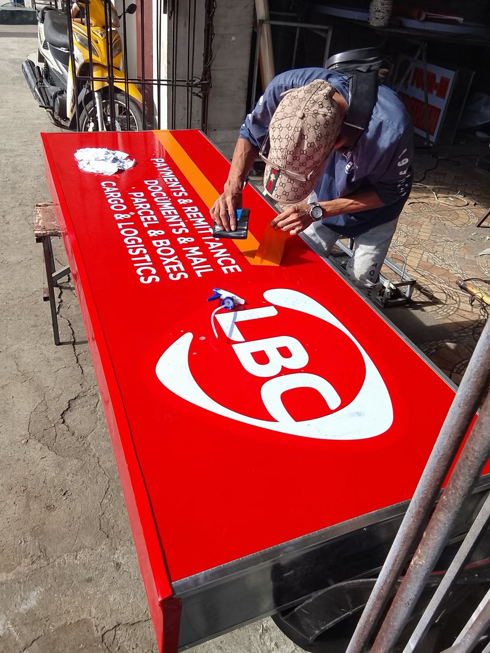 Signstar worker finishing an LBC lightbox in the workshop
