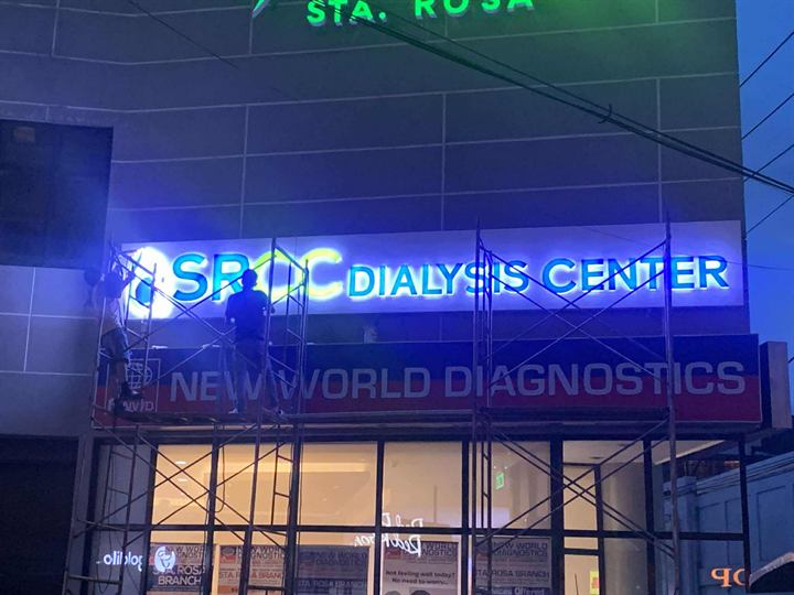 SPDC Dialysis Center blue-lit letters at night
