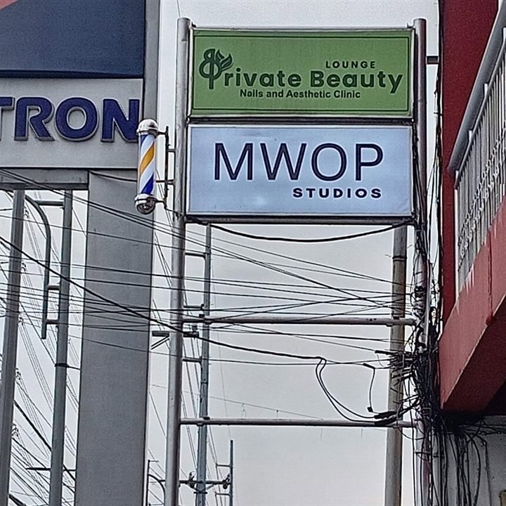 Private Beauty and MWOP Studios lightbox signs on a pole