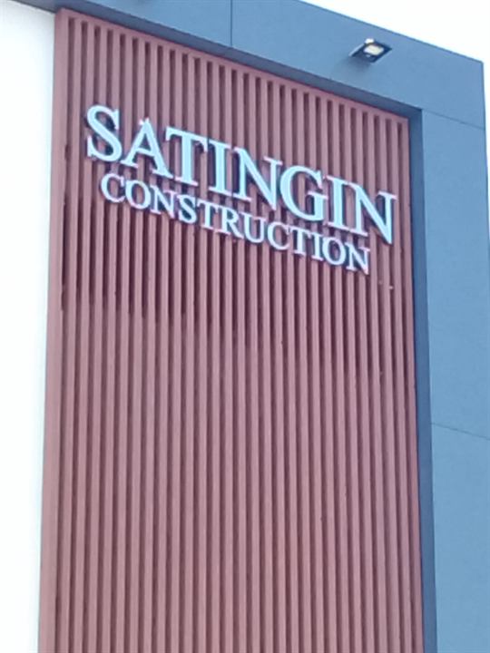 Satingin Construction stainless steel letters on a red panel